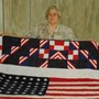Arva with one of her quilts (made from a flag sent to Jan by John F. Kennedy)