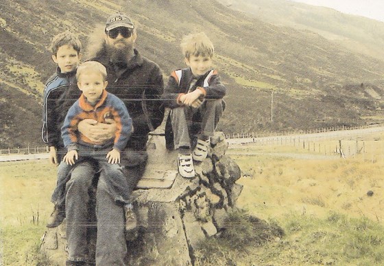 A photo of Iain and his three sons on a holiday trip to Gairloch in Scotland.