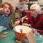 Z instructs on proper gingerbread house construction. Gran eyes with some trepidation. 