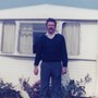 Dad standing in front of our caravan at Blue Anchor Bay