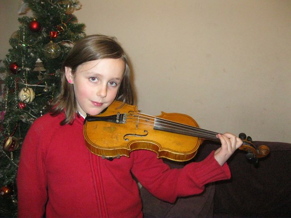 Alice demonstrating the violin for her &#39;Music Passion project&#39;